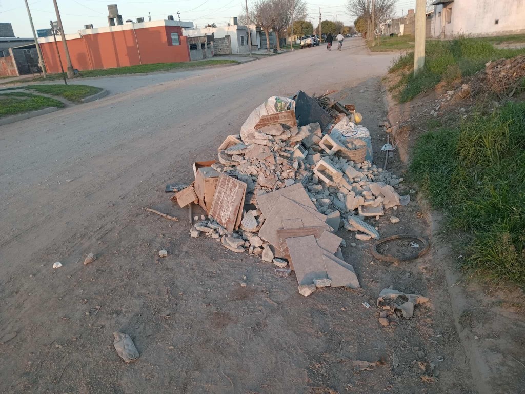 VECINOS ARROJAN MALEZAs EN EL FRENTE DE UN BALDÍO